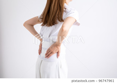 A woman wearing a belt for low back pain A woman wearing a belt for low back pain 96747961