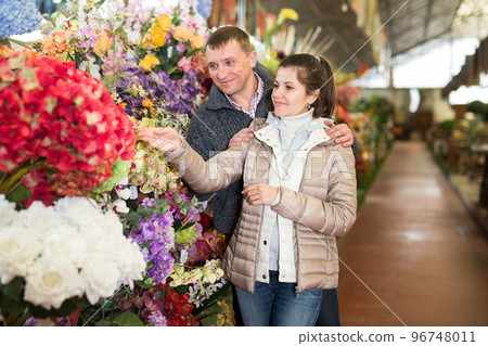 Couple choosing flowers at flower shop Couple choosing flowers at flower shop 96748011