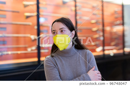 Woman in protective mask viewing ancient guns in history museum 96748047