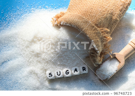 Sugar on sack and blue background, white sugar for food and sweets dessert candy heap of sweet sugar crystalline granulated Sugar on sack and blue background, white sugar for food and sweets dessert candy heap of sweet sugar crystalline granulated 96748723