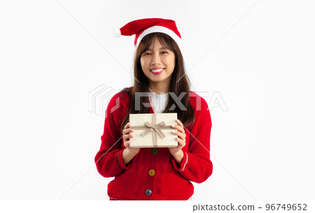 Asian woman long hair wear red sweater looking camera holding preset box smiling on white backtound. Merry Christmas. Asian woman long hair wear red sweater looking camera holding preset box smiling on white backtound. Merry Christmas. 96749652