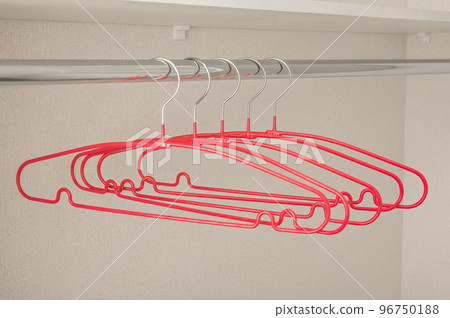 Many pink hangers on rod, grey wall background. Store concept, sale, design, empty hanger. Clothes hangers in empty wardrobe Many pink hangers on rod, grey wall background. Store concept, sale, design, empty hanger. Clothes hangers in empty wardrobe 96750188