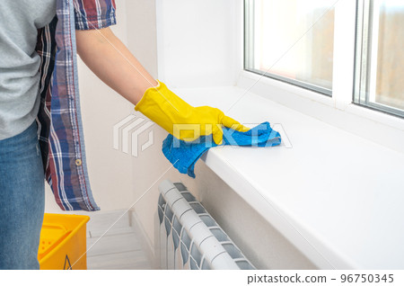 sanitizing service for office and home. cleaning service. female hand with blue rag washing window and window sill at home, cleaning service concept sanitizing service for office and home. cleaning service. female hand with blue rag washing window and window sill at home, cleaning service concept 96750345
