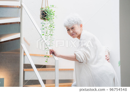 Elderly woman suffering from back pain on stairs 96754548