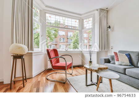 Shabby wooden table with chairs and vase located near comfortable couch against light walls with decorations and TV in modern apartment Shabby wooden table with chairs and vase located near comfortable couch against light walls with decorations and TV in modern apartment 96754633