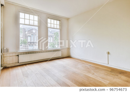 Plastic window and radiator on white wall in empty light room at home Plastic window and radiator on white wall in empty light room at home 96754673
