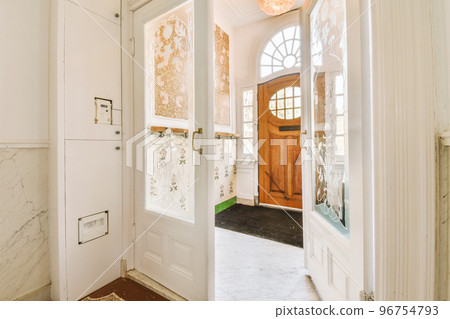 Corridor of contemporary apartment with doorway leading to terrace 96754793