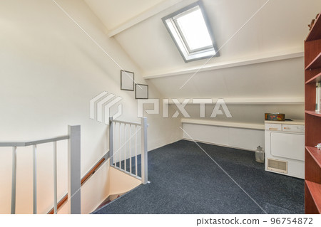 Modern cupboard and vintage chest placed near doors and wicker basket in spacious room with white walls and wooden floor Modern cupboard and vintage chest placed near doors and wicker basket in spacious room with white walls and wooden floor 96754872