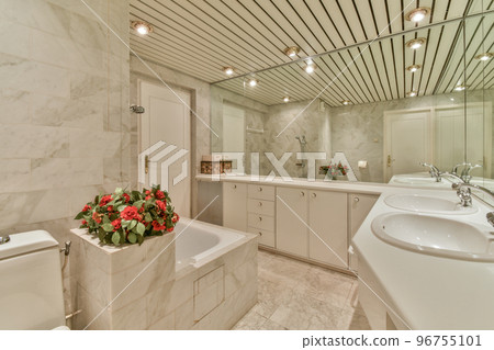 Modern home interior design of white bathroom with open bathtub and shower separated from toilet by partition wall 96755101