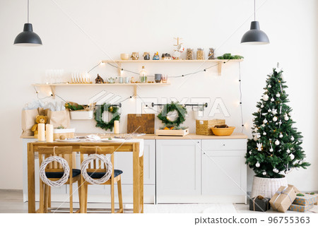 Scandinavian kitchen interior with dining tables decorated for Christmas and New Years. 96755363