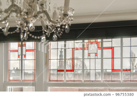 Assorted cookware and appliances placed on counters with white cabinets above in contemporary kitchen at home 96755380