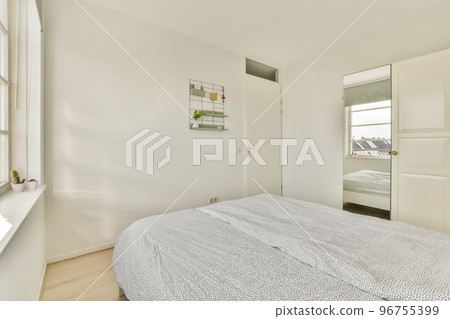 Comfortable bed and cupboard located in in contemporary bedroom at home Comfortable bed and cupboard located in in contemporary bedroom at home 96755399