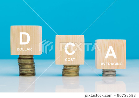 DCA word on a wooden cubes on coins in idea Dollar Cost Averaging investment strategy, Saving stock or savings on a monthly, quarterly basis 96755588