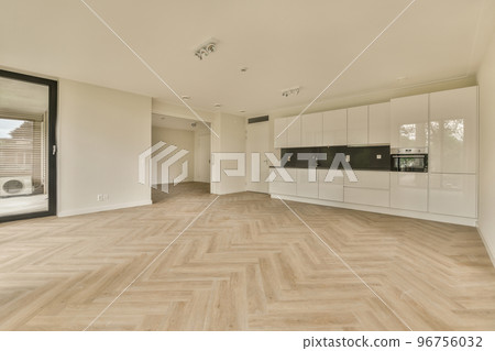 Interior of empty white kitchen with windows and wooden parquet floor 96756032