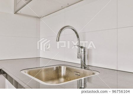 Interior of empty white kitchen with windows and wooden parquet floor Interior of empty white kitchen with windows and wooden parquet floor 96756104