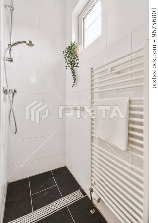 Stylish bathroom interior design with white toilet and bathtub with glass shower in modern apartment Stylish bathroom interior design with white toilet and bathtub with glass shower in modern apartment 96756801