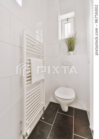 Stylish bathroom interior design with white toilet and bathtub with glass shower in modern apartment Stylish bathroom interior design with white toilet and bathtub with glass shower in modern apartment 96756802