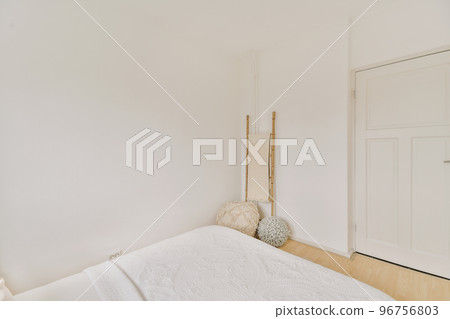 Home interior design of bedroom with bed and wooden wardrobe placed in corner near window in modern apartment Home interior design of bedroom with bed and wooden wardrobe placed in corner near window in modern apartment 96756803