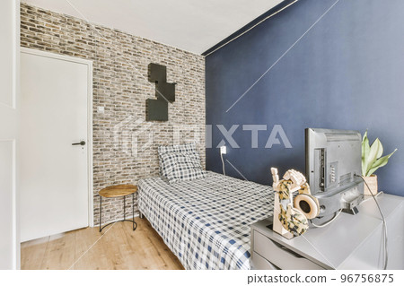 Home interior design of bedroom with bed and wooden wardrobe placed in corner near window in modern apartment 96756875