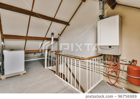 Closed white door of room located near framed pictures and stylish lamp on top of stairway at home Closed white door of room located near framed pictures and stylish lamp on top of stairway at home 96756989