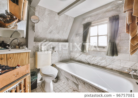 Stylish bathroom interior design with white toilet and bathtub in modern apartment 96757081