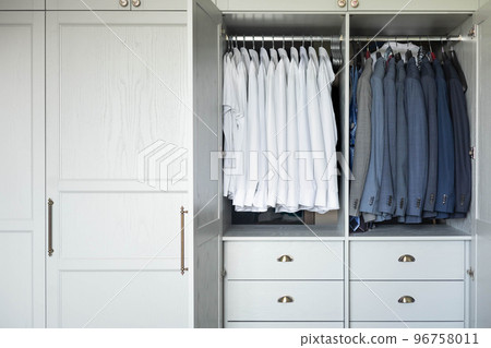 Male wardrobe furniture for business clothing neatly storage organization. Man closet with garment 96758011