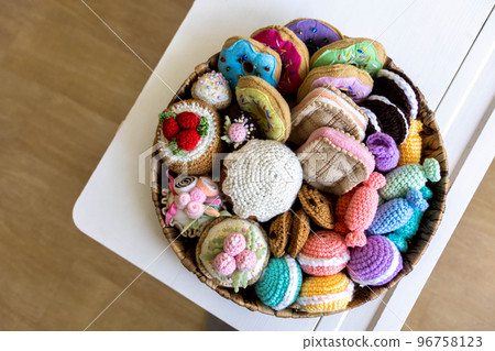 Toy food knitted from yarn. Sweets, pastries, cookies and cakes. 96758123
