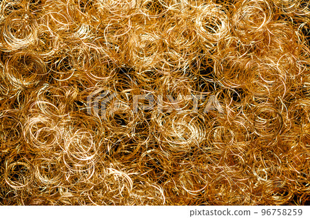 Golden metallic angel hair, background, from above. Curly gold lametta angel hair, made from very thin plated copper wire. Special decoration, used to decorate Christmas trees and Christmas wreaths. 96758259
