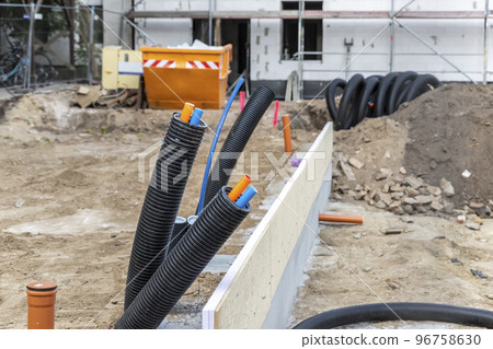 Black PVC flexible corrugated plastic insulation pipes tubing of electrical cables wire at undeground installation. New modern building construction site with engineering pipeline drainage technology 96758630