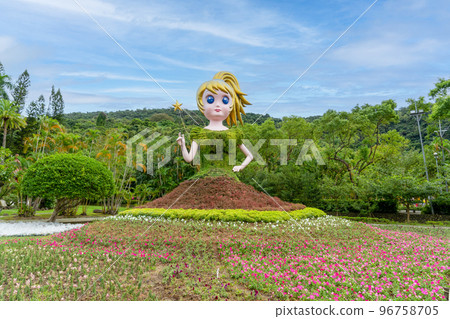 The fairy is holding a fairy wand and her green dress and red skirt are plants. The fairy is holding a fairy wand and her green dress and red skirt are plants. 96758705