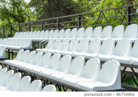 Seats of tribune on sport stadium. Concept of fans, chairs for audience, cultural environment concept. mpty seats, modern stadium. 96758902