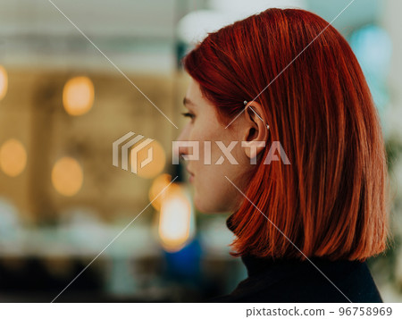 Headshot portrait of a modern woman in the office at night by the window Headshot portrait of a modern woman in the office at night by the window 96758969