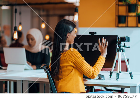 A young woman using a camera to present her business with online clients  96759177