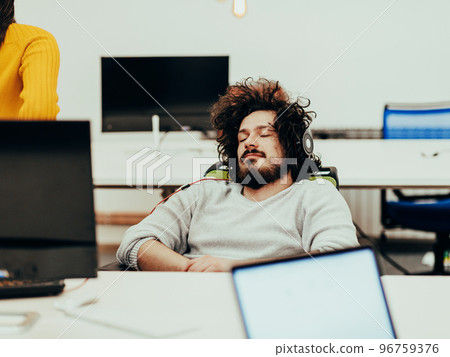 Businessman slepping on chair in business company office 96759376