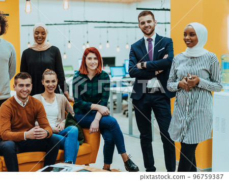 Multiethnic group of employees working in a marketing company. A group of colleagues is working on a project in modern offices 96759387