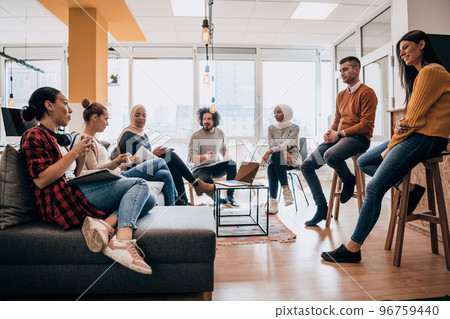 Young designer giving some new ideas about project to his partners in conference room. Business people discussing over new business project in office. Young designer giving some new ideas about project to his partners in conference room. Business people discussing over new business project in office. 96759440