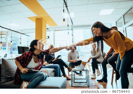 Close-up photo of two woman shaking hands in a fashionable way Close-up photo of two woman shaking hands in a fashionable way 96759443