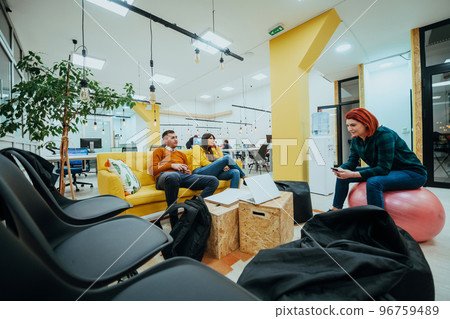 Multiethnic group of employees working in a marketing company. A group of colleagues is working on a project in modern offices Multiethnic group of employees working in a marketing company. A group of colleagues is working on a project in modern offices 96759489