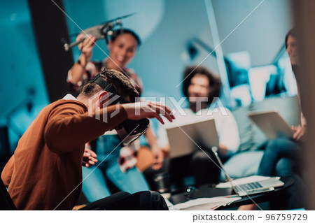 Business persons with a disability at work in modern open space coworking office on team meeting using virtual reality goggles. 96759729