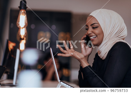 Young African American businesswoman talking on a smartphone in a modern startup office. Marketing concept. Multi-ethnic society. 96759733