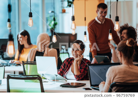 Multiethnic group of employees working in a marketing company. A group of colleagues is working on a project in modern offices Multiethnic group of employees working in a marketing company. A group of colleagues is working on a project in modern offices 96759769