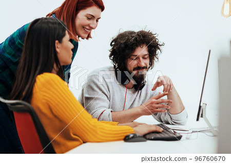 Multiethnic group of employees working in a marketing company. A group of colleagues is working on a project in modern offices Multiethnic group of employees working in a marketing company. A group of colleagues is working on a project in modern offices 96760670