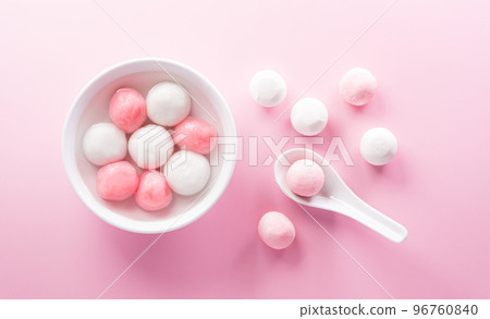 Tang Yuan(sweet dumplings balls), a traditional cuisine for Mid-autumn, Dongzhi (winter solstice ) and Chinese new year food on pastel background. Tang Yuan(sweet dumplings balls), a traditional cuisine for Mid-autumn, Dongzhi (winter solstice ) and Chinese new year food on pastel background. 96760840
