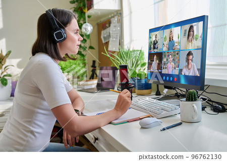 Teacher looking at pc screen, online lesson with group of teenage students Teacher looking at pc screen, online lesson with group of teenage students 96762130