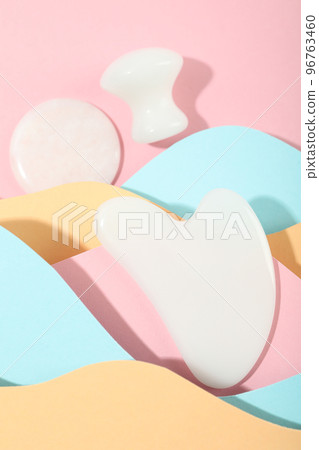 Face care concept with gua sha on multicolor background Face care concept with gua sha on multicolor background 96763460