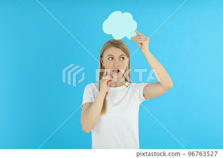 Young woman with speech bubble on blue background 96763527