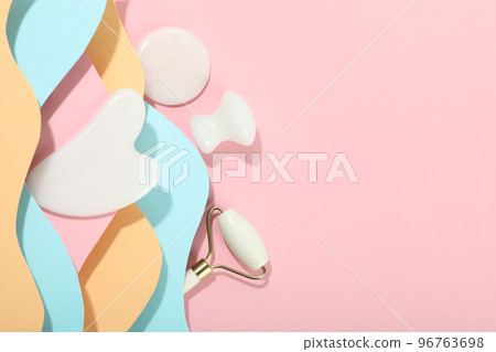 Face care concept with gua sha kit on multicolor background Face care concept with gua sha kit on multicolor background 96763698
