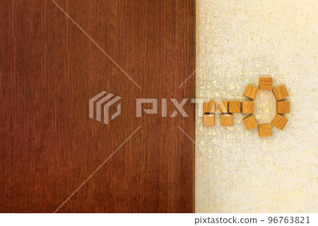Background of inserting keys arranged in wood cubes on a brown door board 96763821