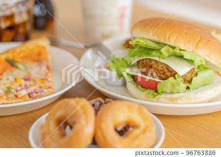 Hamburger on the table, pizza, donut, cup noodles, cola 96763886