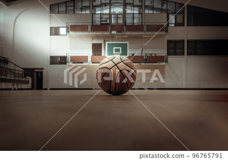 Basketball ball placed on court floor in the basketball gym. 96765791